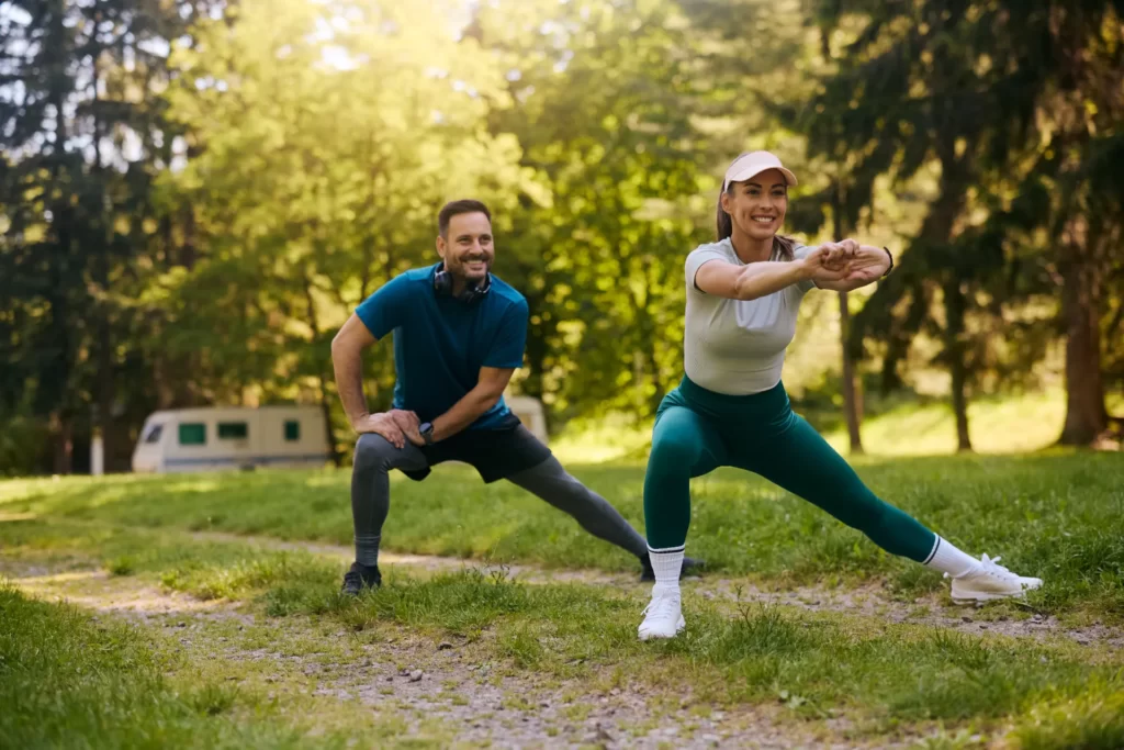 couple stretching outdoors during sunny day in the utc