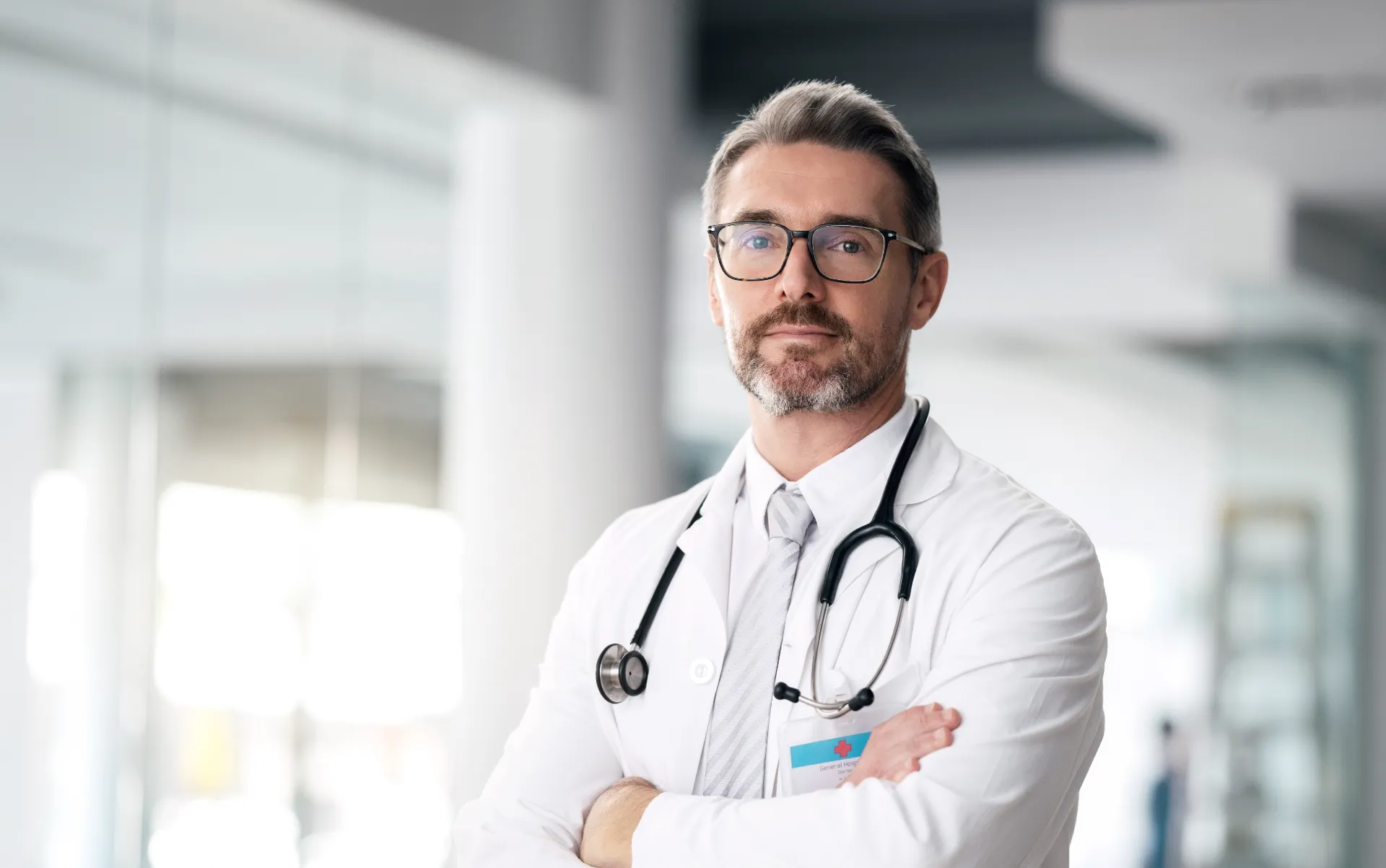 serious doctor portrait and man with arms crossed utc